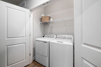 A white washer and dryer in a small laundry room.